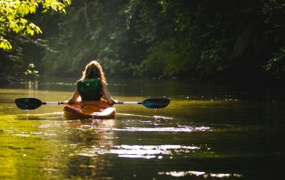 woman kayaking on a river